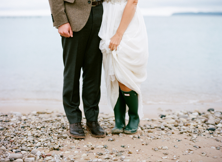 Bride and groom pose for portraits on the shore of Lake Michigan near Sleeping Bear Dunes after their elopement by Ann Arbor Michigan Wedding Photographer Heather Jowett.