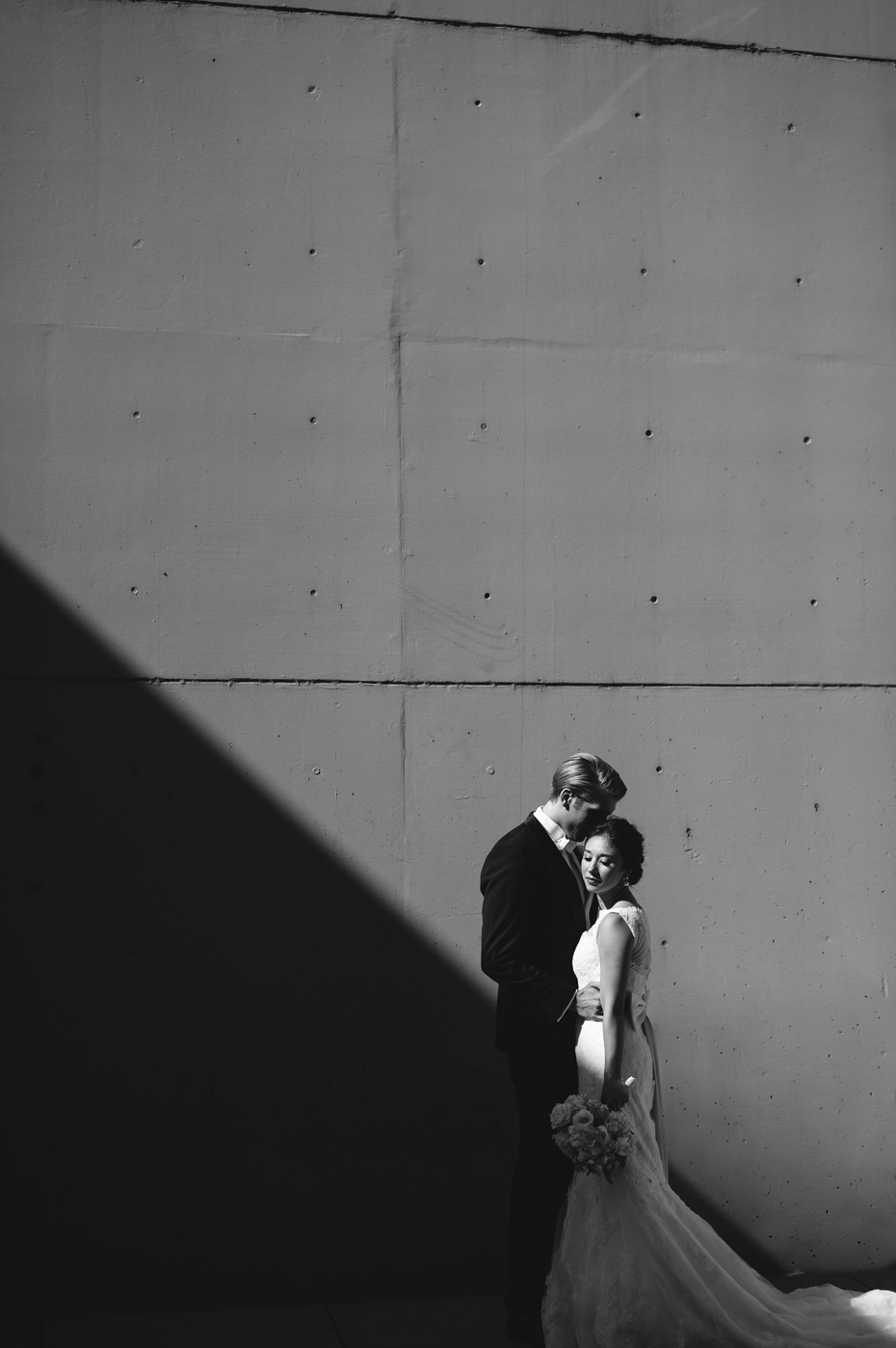 Bride and groom pose for portraits outside of the Amway Grand Hotel in Grand Rapids by Michigan wedding Photographer Heather Jowett