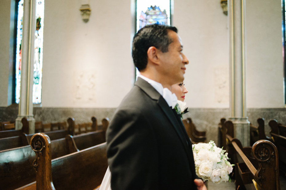 Wedding Photograph of bride and her father walking down the aisle at The Cathedral of Saint Andrew in Grand Rapids Michigan