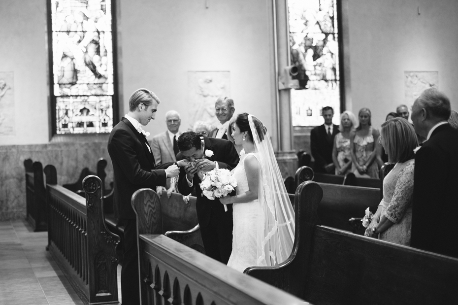 Wedding Photograph of bride being given away by her father at The Cathedral of Saint Andrew in Grand Rapids Michigan