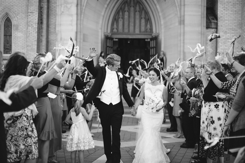 Streamers fly as the Bride and groom exit the church at The Cathedral of Saint Andrew in Grand Rapids Michigan