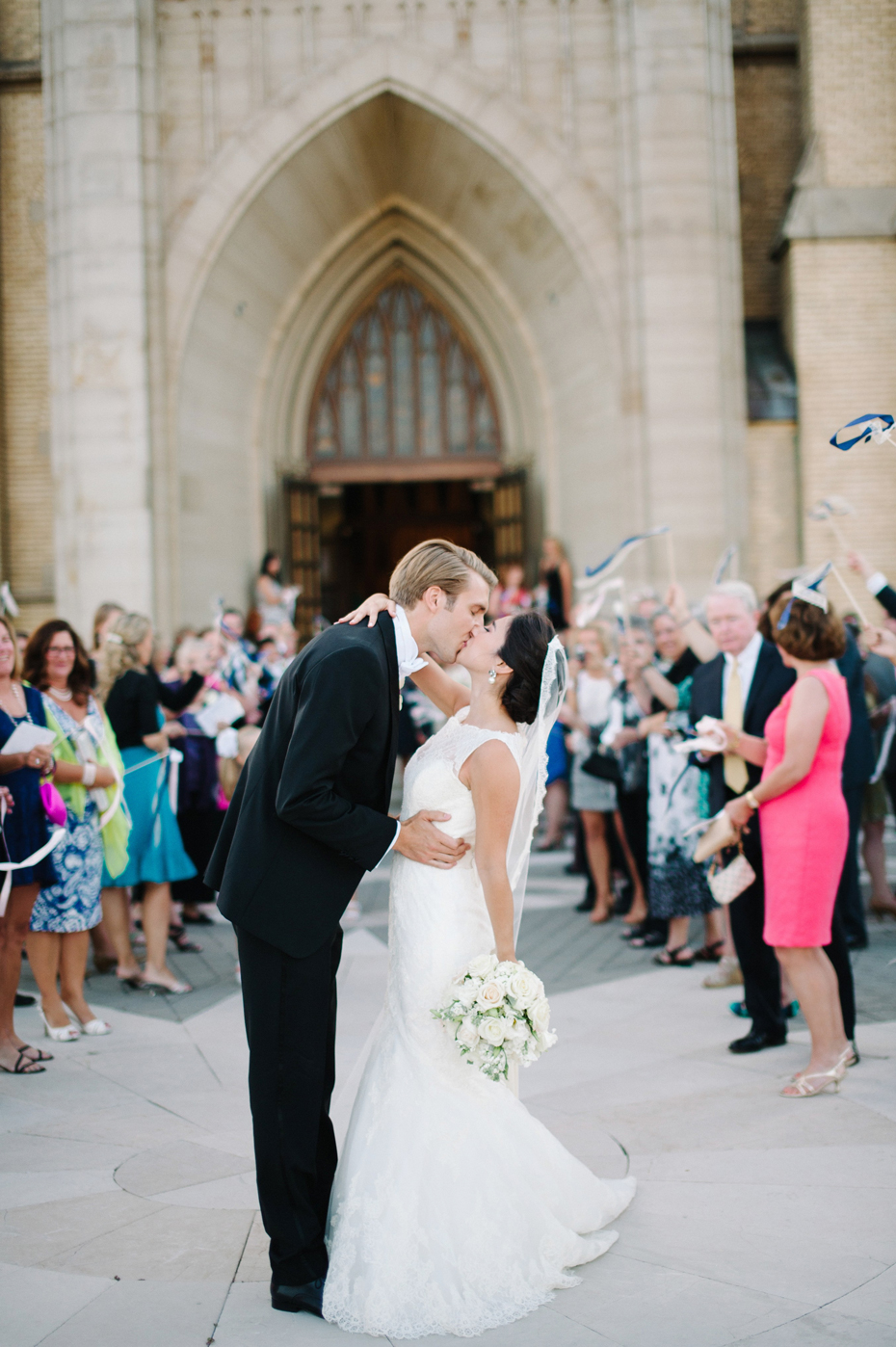 Streamers fly as the Bride and groom exit the church at The Cathedral of Saint Andrew in Grand Rapids Michigan