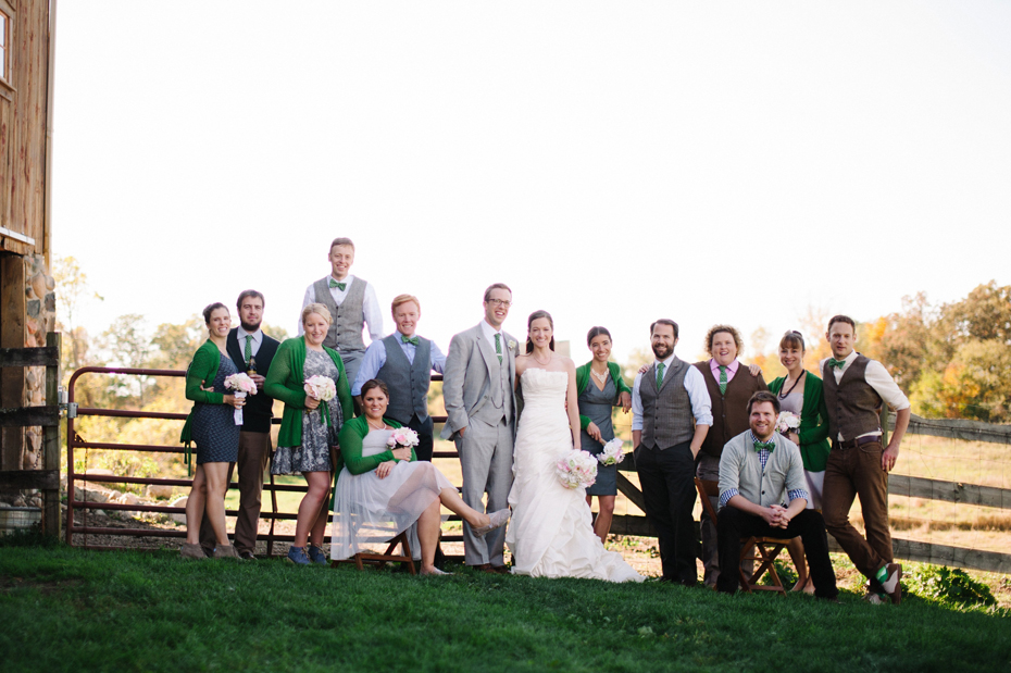 The wedding party poses by the barn at Misty Farms by photojournalistic Michigan wedding photographer Heather Jowett.