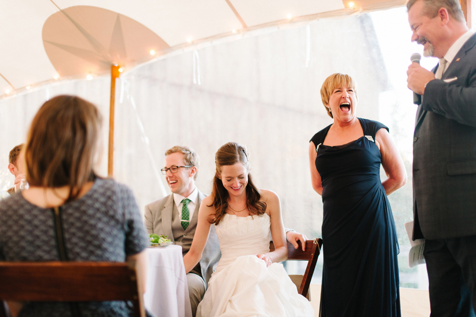 Laughter filled toasts during a wedding reception at Misty Farms by photojournalistic Michigan wedding photographer Heather Jowett.