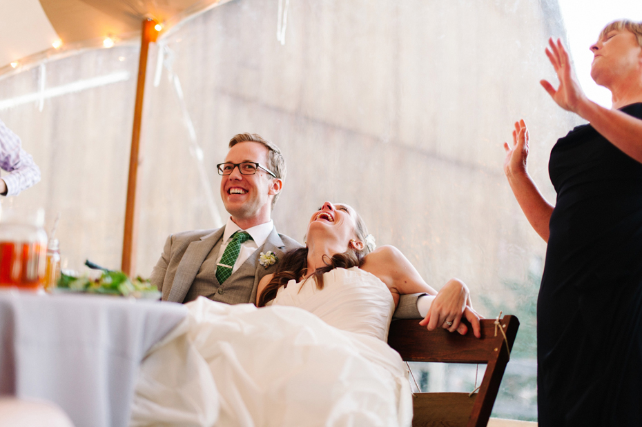 Laughter filled toasts during a wedding reception at Misty Farms by photojournalistic Michigan wedding photographer Heather Jowett.