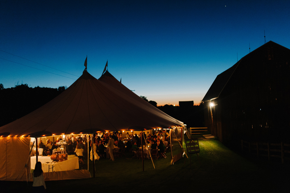 The tent and the sunset at a wedding reception at Misty Farms by photojournalistic Michigan wedding photographer Heather Jowett.