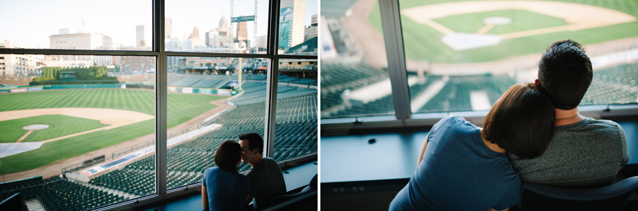 A couple posing in the press box during their engagement session at Comerica Park.