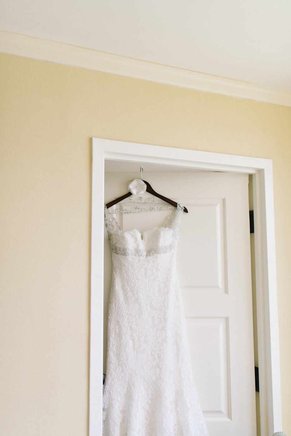 The bride's wedding dress hangs on a custom hanger at the City Center Marriot in Newport News.