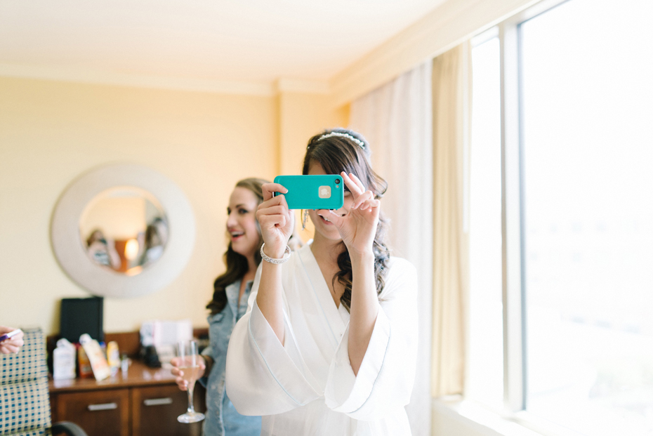 The bride takes a quick snap chat break before getting dressed by Virginia Wedding Photographer, Heather Jowett.