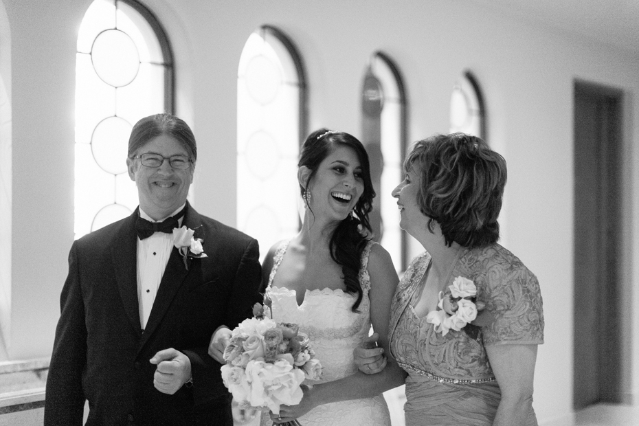 The bride shares one last moment with her parents before before her Greek Orthodox ceremony at Saints Constantine & Helen Greek Orthodox Church in Newport News by Virginia Wedding Photographer, Heather Jowett.