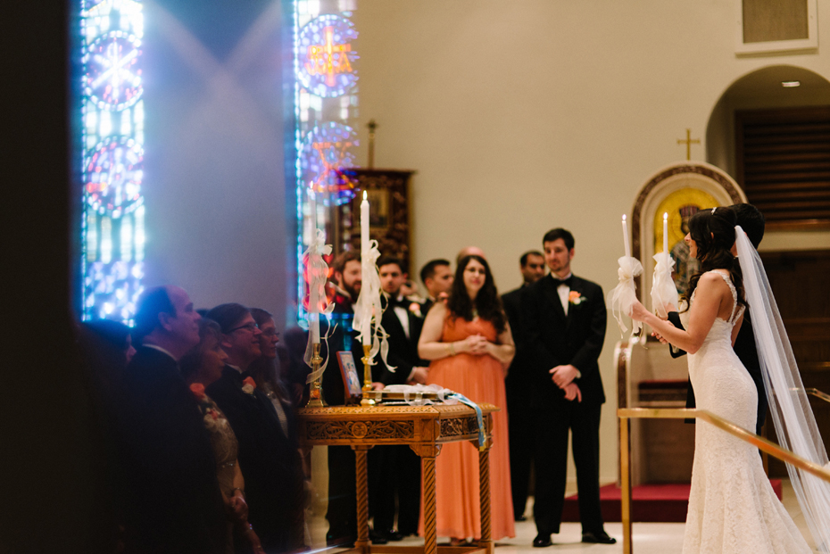 Parents look on at Saints Constantine & Helen Greek Orthodox Church in Newport News by Virginia Wedding Photographer, Heather Jowett.