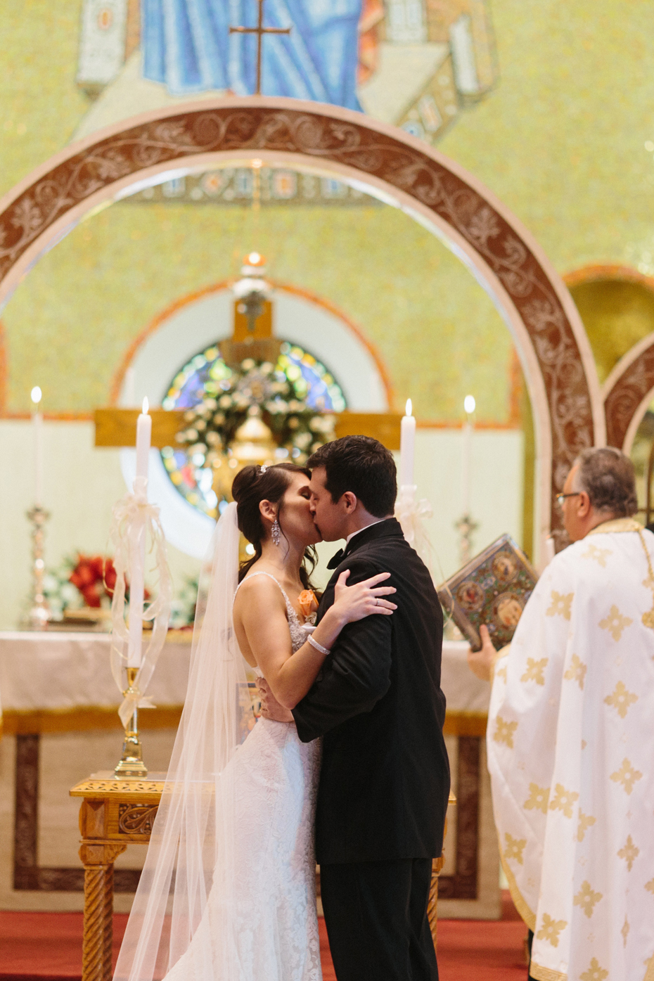 First kiss at Saints Constantine & Helen Greek Orthodox Church in Newport News by Virginia Wedding Photographer, Heather Jowett.