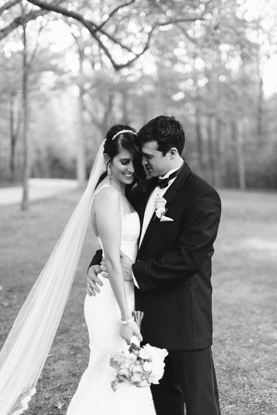 Bride and groom snuggle close at the Noland Trail by Virginia Wedding Photographer, Heather Jowett.