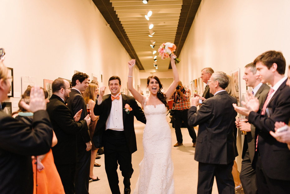 Bride and groom enter their wedding reception at PFAC, the Peninsula Fine Arts Center in Newport News by Virginia Wedding Photographer, Heather Jowett.