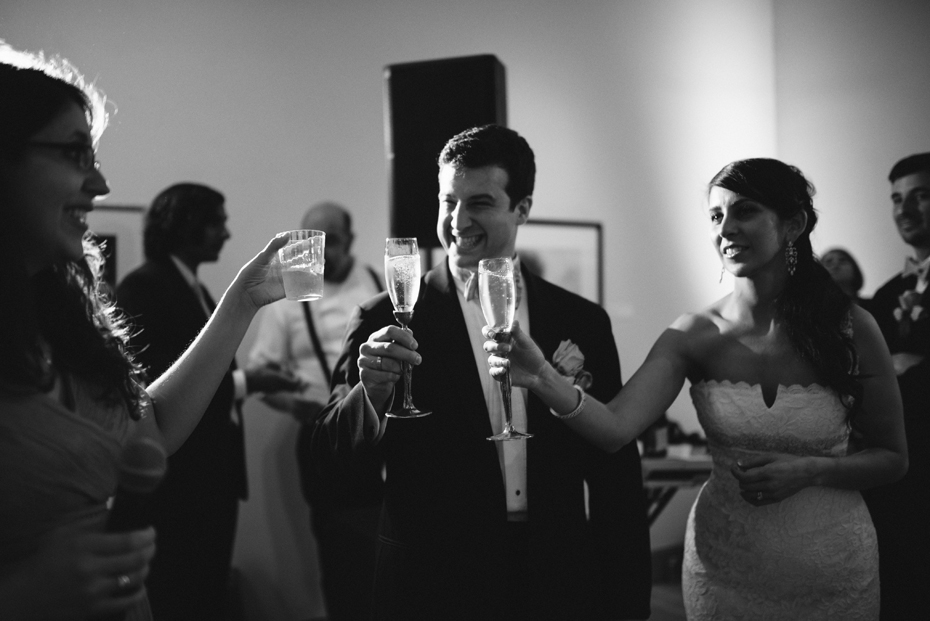 Champagne toasts at a wedding reception at PFAC, the Peninsula Fine Arts Center in Newport News by Virginia Wedding Photographer, Heather Jowett.