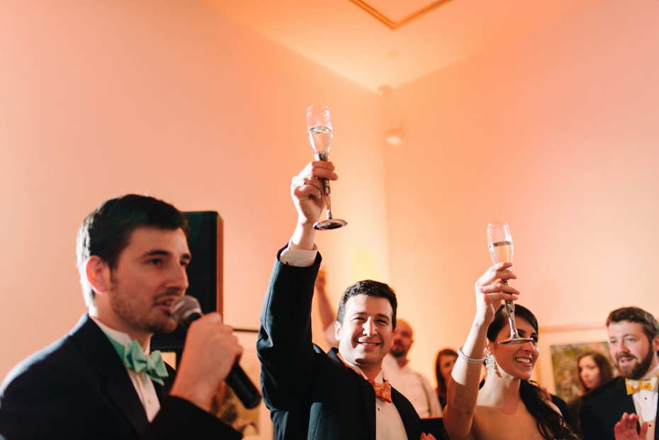 Cheers to the couple at a wedding reception at PFAC, the Peninsula Fine Arts Center in Newport News by Virginia Wedding Photographer, Heather Jowett.