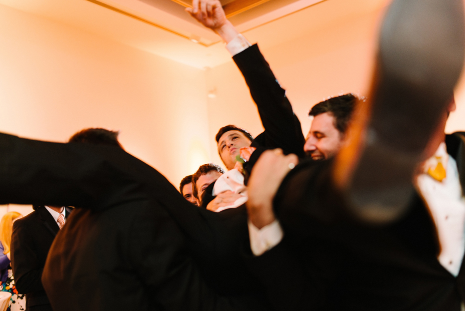 The groom is lifted by the groomsmen at a PFAC wedding reception by Virginia Wedding Photographer, Heather Jowett.