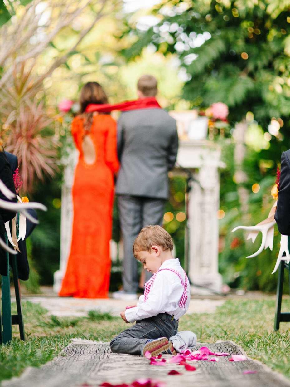 The ring bearer takes a break during A wedding ceremony at the Sundy house.