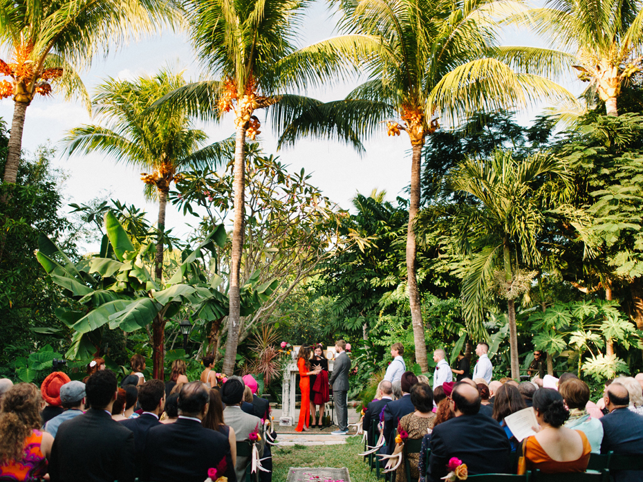 Palm trees look over A wedding ceremony at the Sundy house.