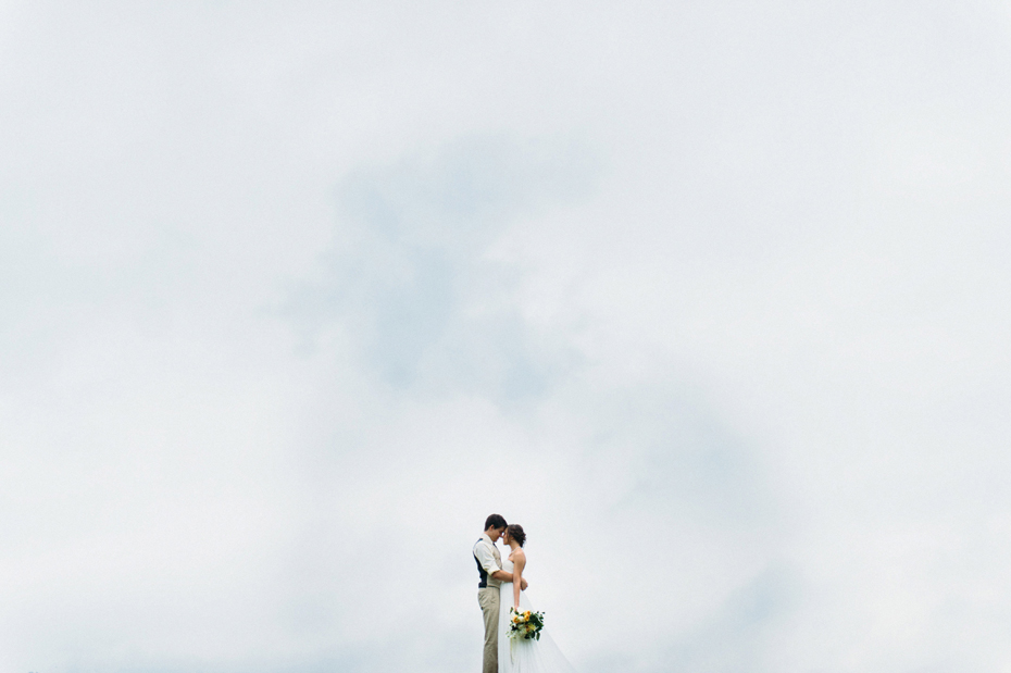 Bride and groom portrait with stormy sky.