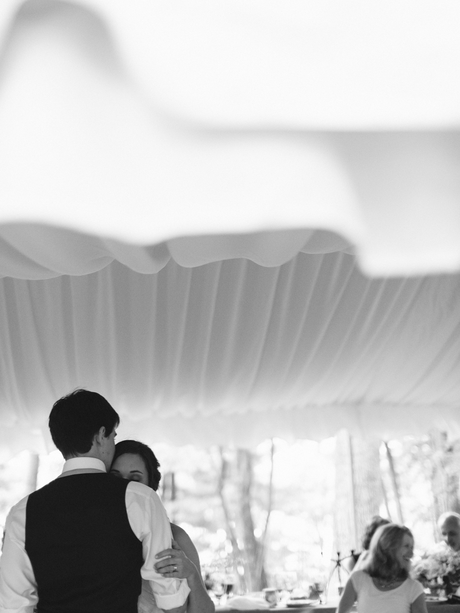 Bride and groom sharing an emotional first dance at their rustic wedding by photojournalistic wedding photographer heather jowett.