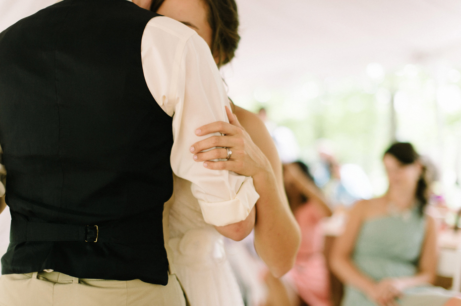 Bride and groom sharing an emotional first dance at their rustic wedding by photojournalistic wedding photographer heather jowett.