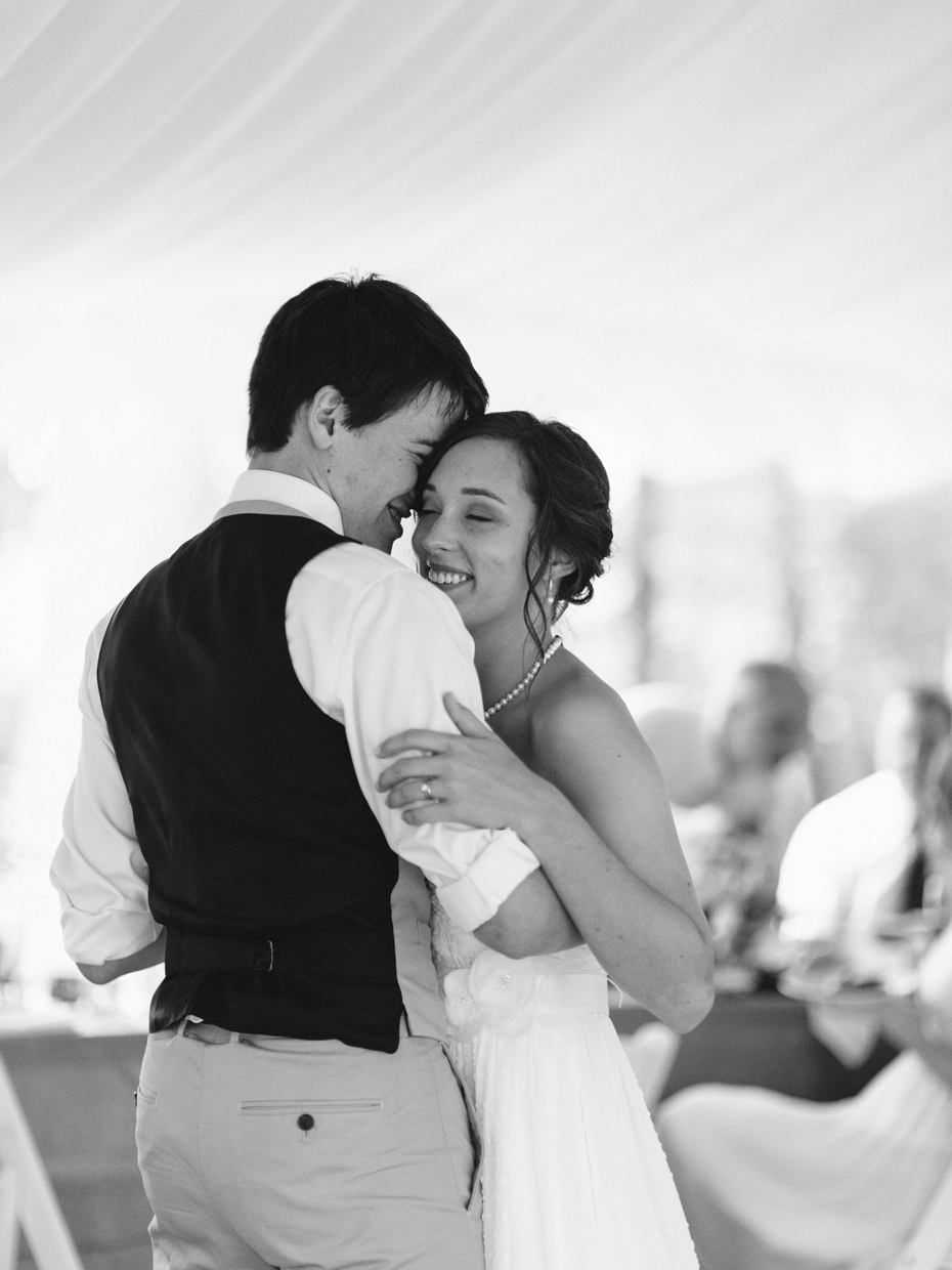 Bride and groom sharing an emotional first dance at their rustic wedding by photojournalistic wedding photographer heather jowett.