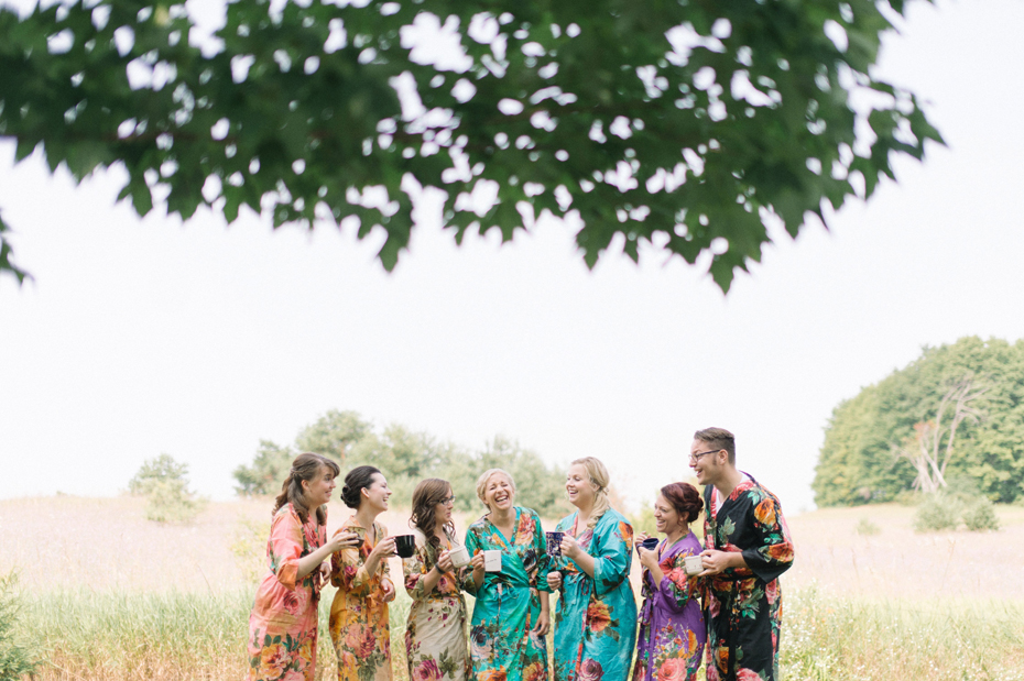 The Bride and her Bridesmaids wear matching floral robes while getting ready.