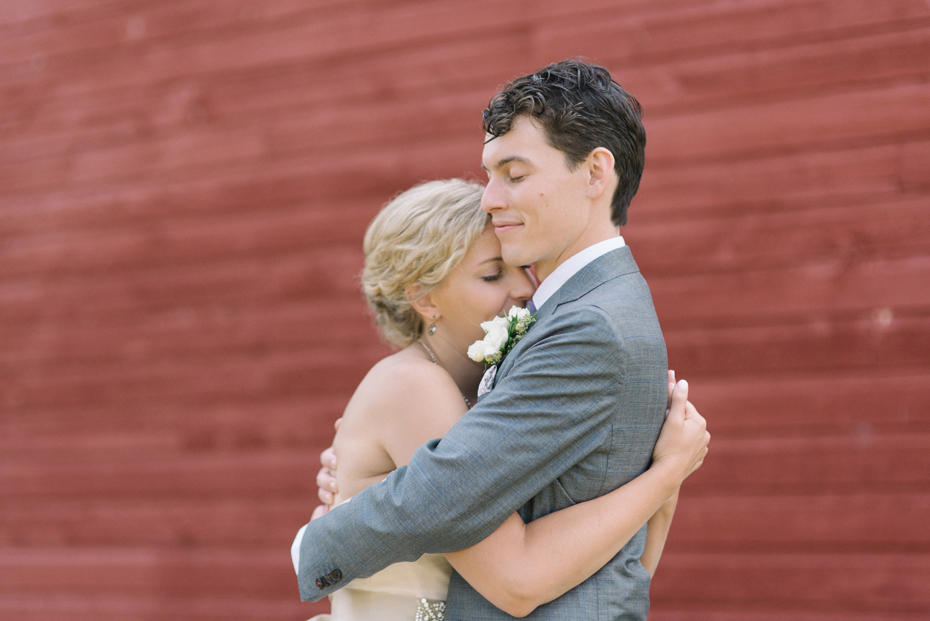 The bride and groom share their first look by a barn before their wedding at Tapawingo in Northern Michigan, by Ann Arbor Wedding Photographer Heather Jowett.