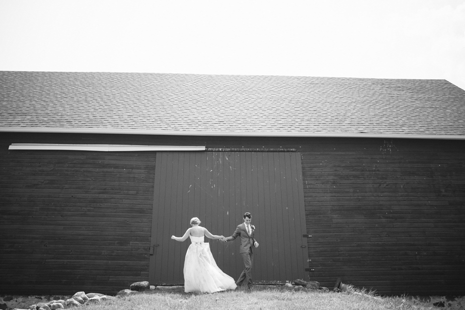 The bride and groom practice their first dance by a barn before their wedding at Tapawingo in Northern Michigan, by Ann Arbor Wedding Photographer Heather Jowett.