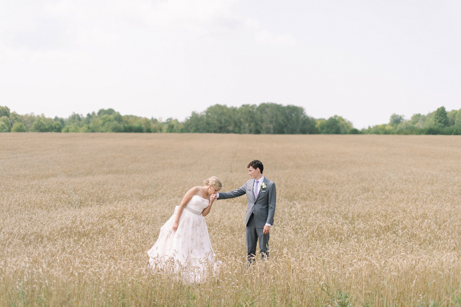 Bride and groom portrait in a wheat field.
