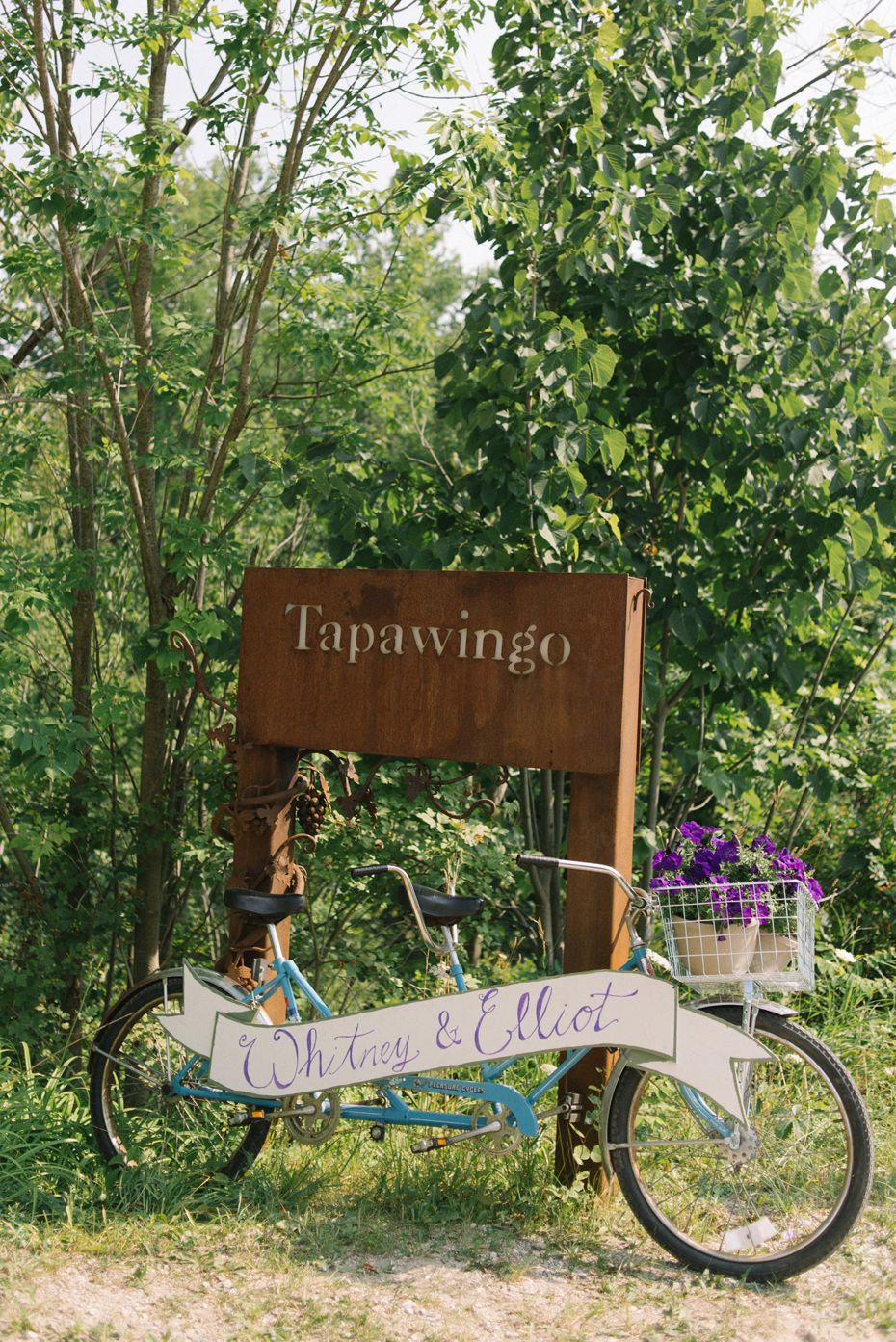 A bike decorates the entrance to a wedding at Tapawingo by Michigan wedding photographer Heather Jowett.