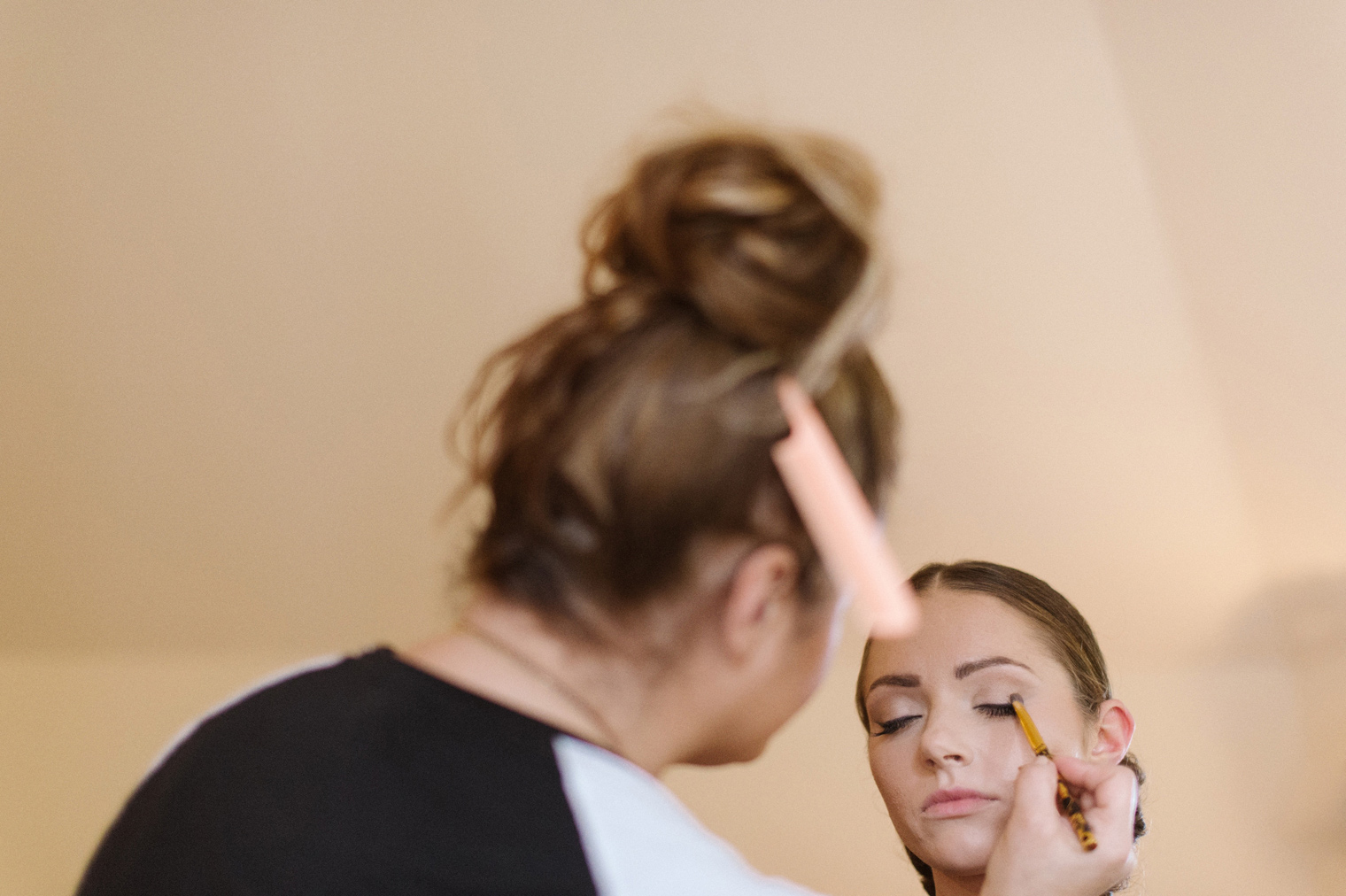 Bride is given last minute touches on her hair and makeup before her Detroit Wedding by photographer Heather Jowett.