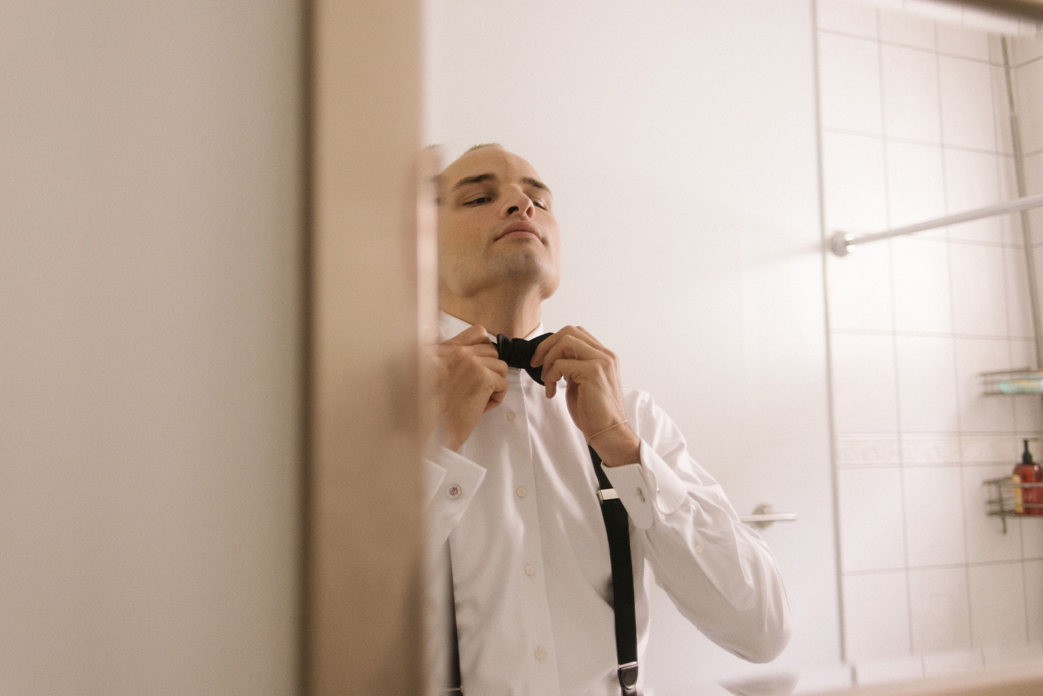 A groom gets dressed in his custom 1701 Bespoke Tuxedo before his Detroit Wedding day.