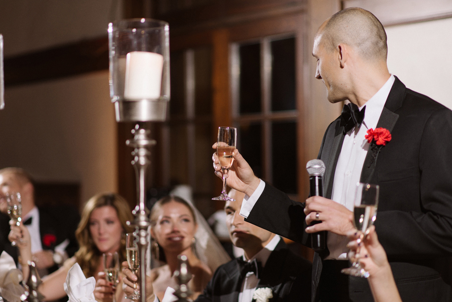 The best man toasts to his brother during a Detroit Yacht Club wedding reception by Photographer Heather Jowett.