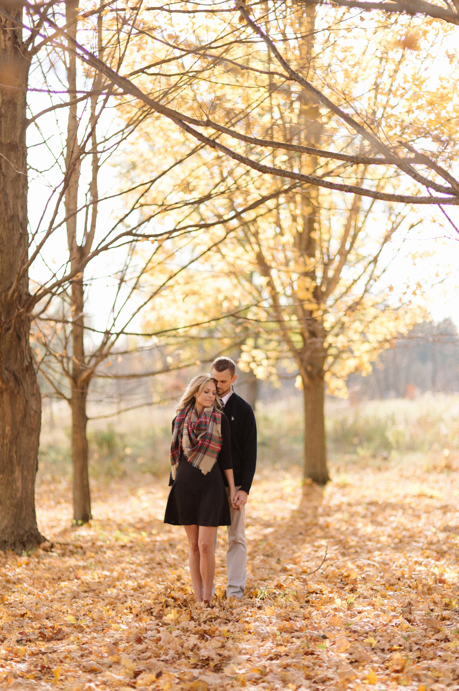 Bright orange and tell fall foliage at a fall couples photography session at the Ann Arbor Botanical Gardens by wedding photographer Heather Jowett