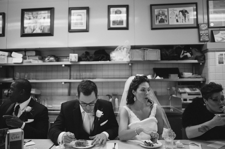 Bride and groom eating coney dogs at Lafayette Coney Island