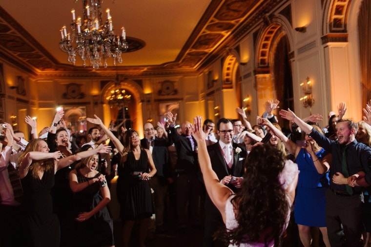 Guests wave their arms at wedding reception at the Colony Club in Detroit