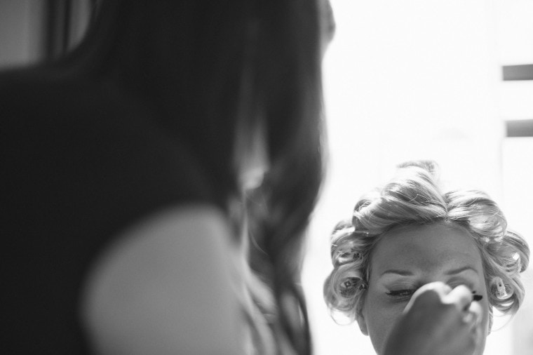 A bride gets her makeup done at the Westin Book Cadillac .