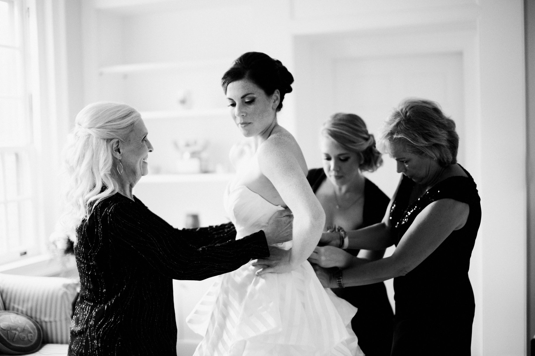 008 mother of the bride helps her into her dress