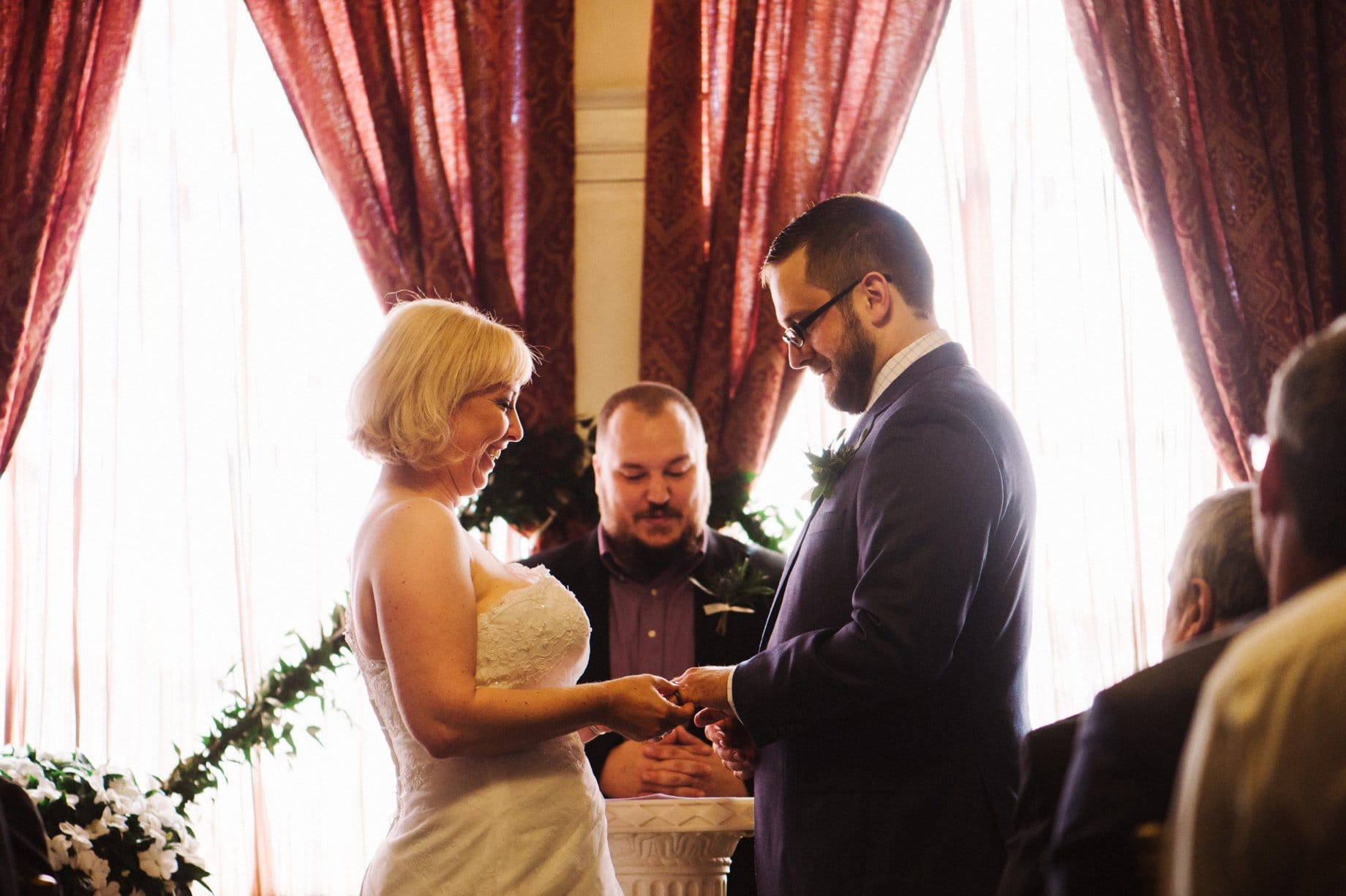 couple exchanging rings during wedding ceremony in the ballroom of the lafayette grande