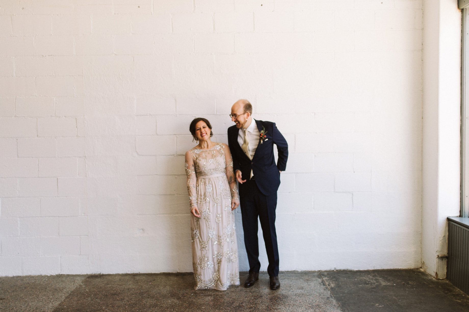 candid and fun portrait of a bride and groom on their wedding day in detroit