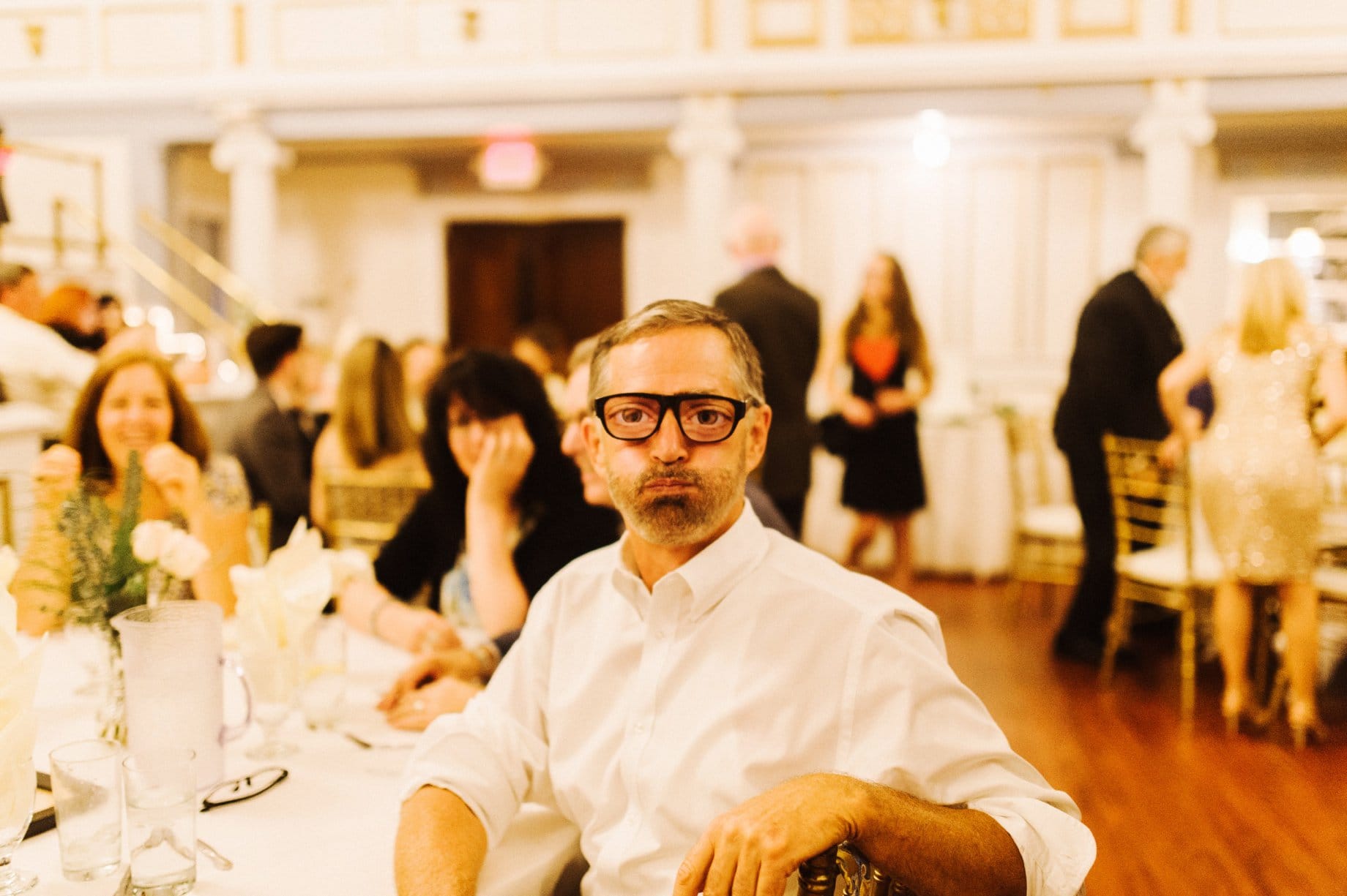wedding guests wearing funny glasses