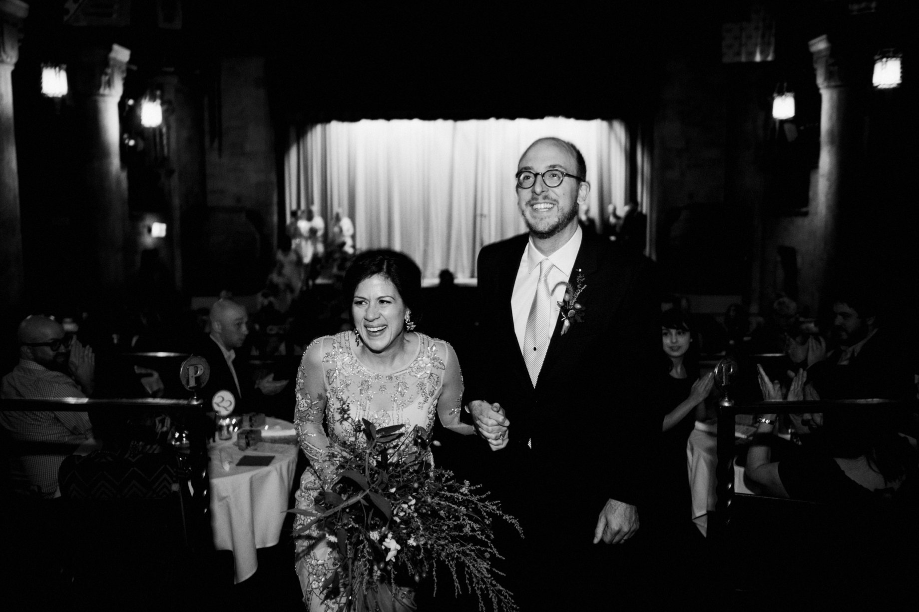 bride and groom are joyous as they exit their wedding ceremony