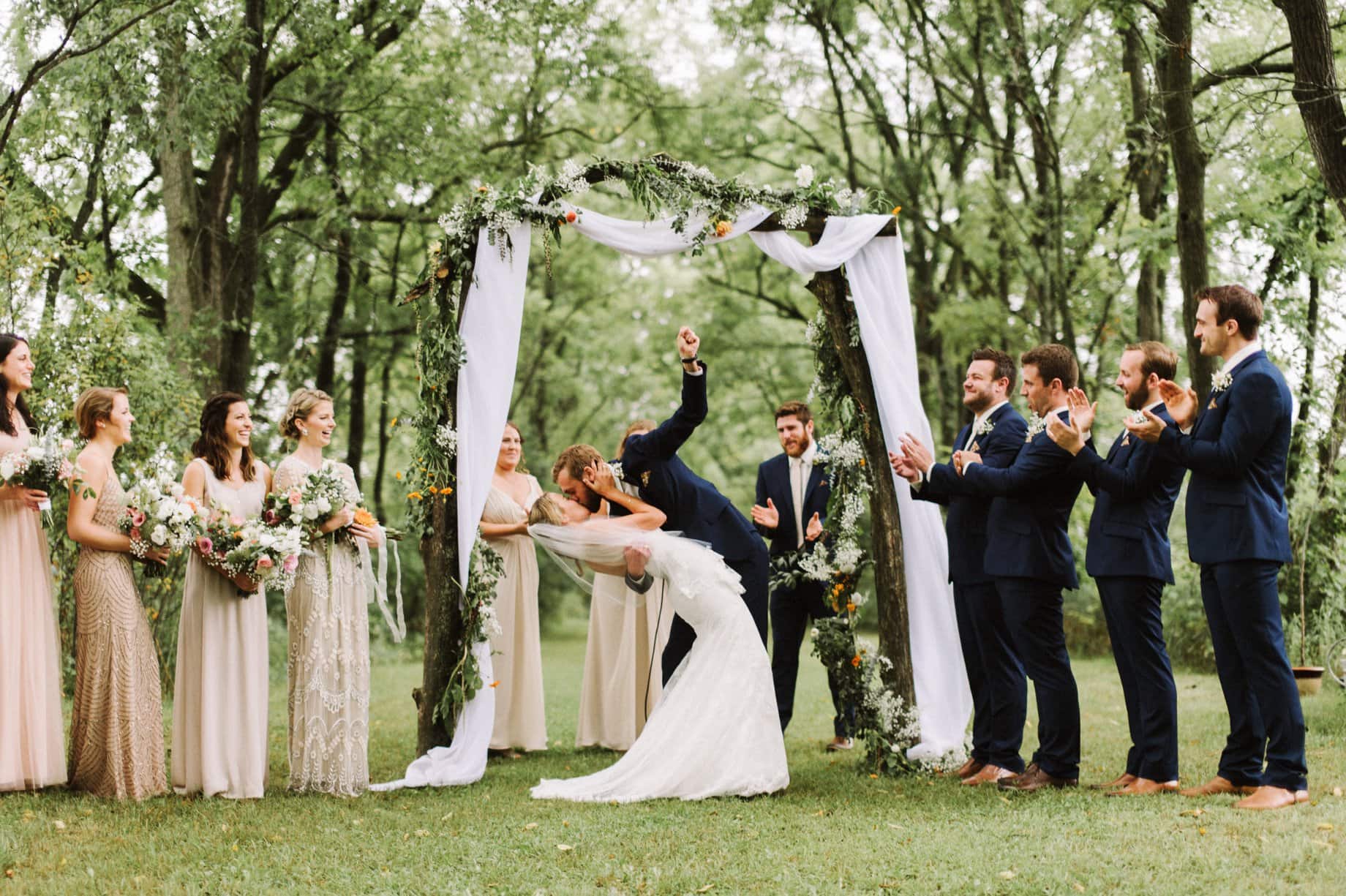 groom fist pumping during first kiss