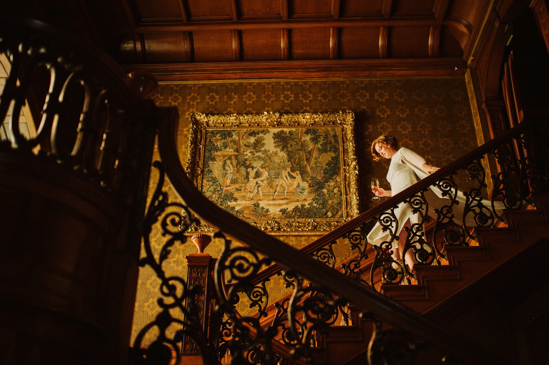 artist bride in flowing white bridal kimono descending the stairs at her detroit wedding