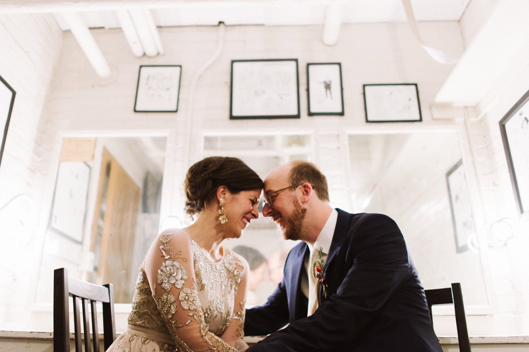 bride and groom pose for portrait in dressing room