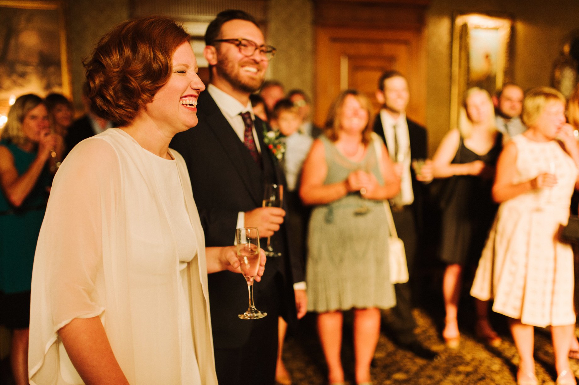 bride and groom reacting to wedding toasts