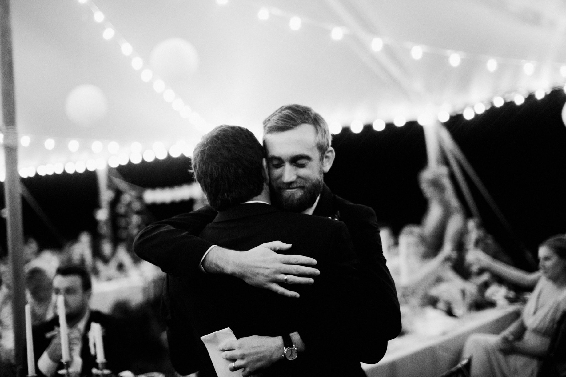 groom hugging best man