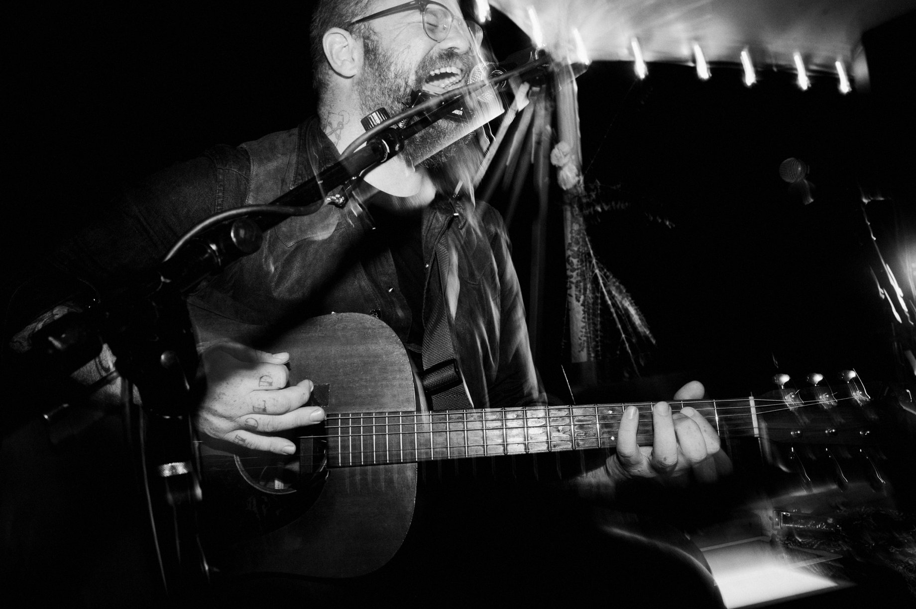 musician playing live at backyard wedding